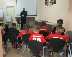 policjantka rozmawia z młodymi piłkarzami