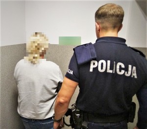 Zdjęcie przedstawia zatrzymaną kobietę oraz umundurowanego policjanta