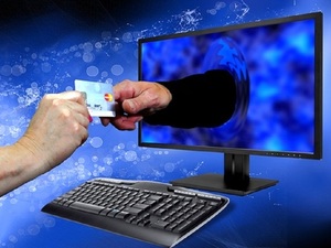 Grafika przedstawiająca rękę przekazująca dokument ręce wychodzącej z monitora