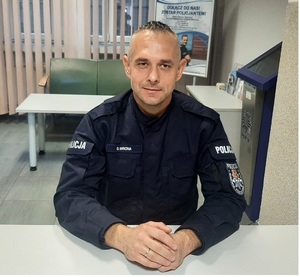 policjant w mundurze siedzący przy stole