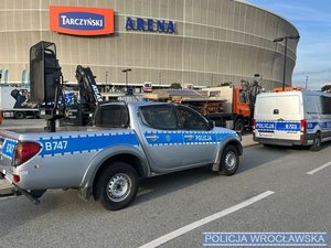 radiowóz na tle stadionu miejskiego we Wrocławiu