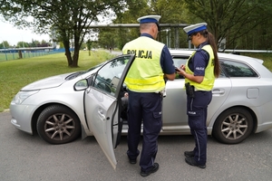 Policjanci ruchu drogowego kontrolujący pojazdy poruszające się ulicami