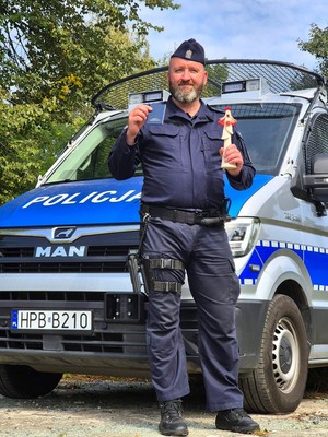 policjant z legitymacją w ręce