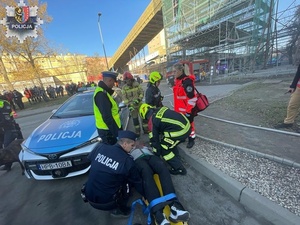 policjanci podczas ćwiczeń umieszczają poszkodowanego na noszach