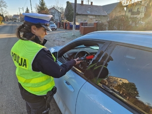 Policjantka podczas spawdzania stanu trzeźwości przy samochodach