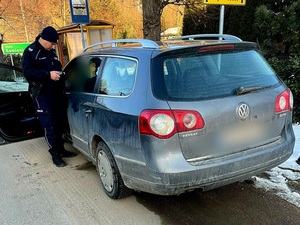 policjant przesłuchuje kierowcę samochodu osobowego