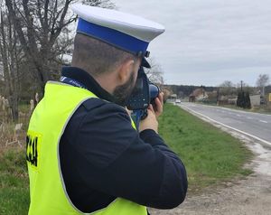 policjant mierzy prędkość nadjeżdżających samochodów