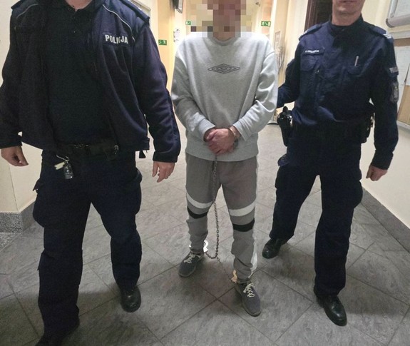 policjanci prowadzą zatrzymanego