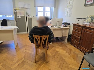 zatrzymany mężczyzna siedzący na krześle podczas przesluchania