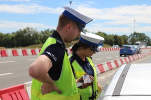 Policjant ruchu drogowego podczas mierzenia prędkości
