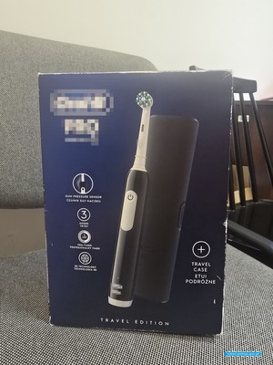 pudełko z elektryczną szczoteczką dom zębów