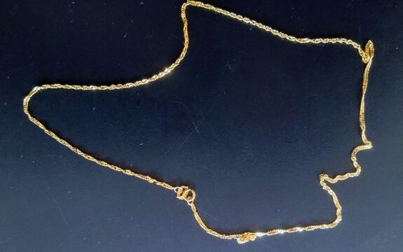 złoty łańcuszek leżący na stole