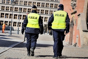 policjant i policjantka patrolują rynek