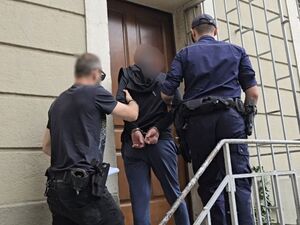 Zdjęcia z prowadzeniem zatrzymanych mężczyzn przez policjantów