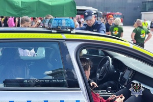 policjanci podczas festynu prezentują sprzęt policyjny i rozmawiają z uczestnikami o bezpieczeństwie