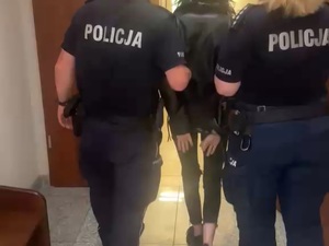 policjantka i policjant prowadzą zatrzymaną