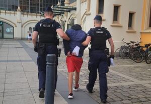 policjanci prowadzą zatrzymanego