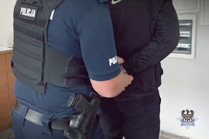 POLICJACI prowadza zatrzymanych