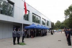 Zdjęcie przedstawia budynek nowego Komisariatu I Policji w Wałbrzychu z siedzibą w Szczawnie-Zdroju, na tle którego znajdują się zaproszeni goście, kadra kierownicza polskiej i dolnośląskiej Policji, policjanci, funkcjonariusze oraz pracownicy Policji.