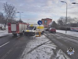 miejsce wypadku na którym widać białego busa i samochód straży pożarnej